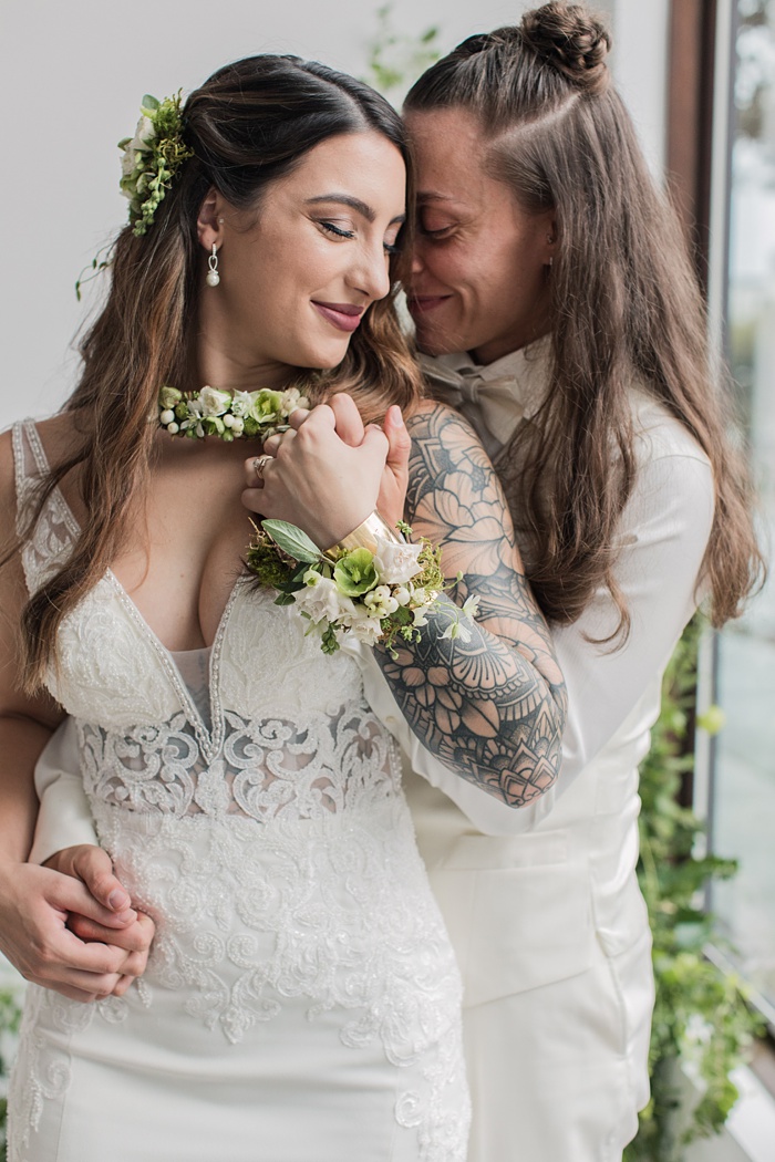 two brides embracing on their wedding day