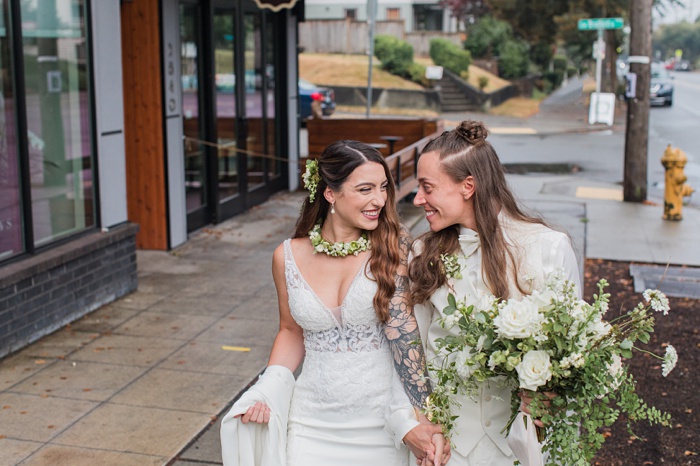 our brides walking down the street in Seattle, holding hands